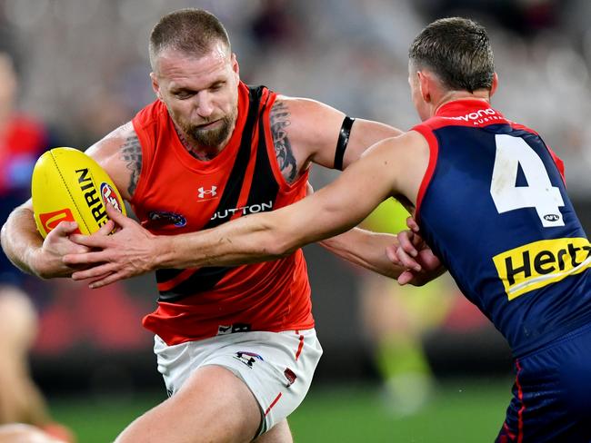 MELBOURNE, AUSTRALIA - JULY 13: Jake Stringer of the Bombers is tackled by Judd McVee of the Demons during the round 18 AFL match between Melbourne Demons and Essendon Bombers at Melbourne Cricket Ground, on July 13, 2024, in Melbourne, Australia. (Photo by Josh Chadwick/AFL Photos/via Getty Images)