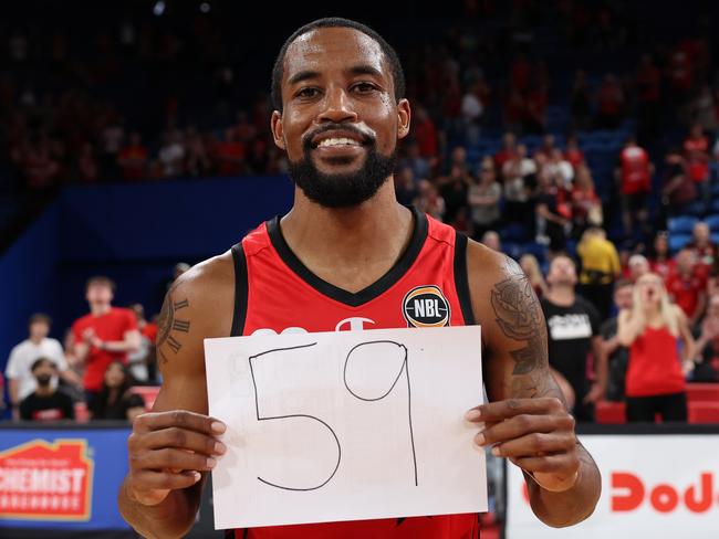 PERTH, AUSTRALIA - DECEMBER 01: Bryce Cotton of the Wildcats poses with a hand written sign showing 59, indicating the number of points he scored during the round 10 NBL match between Perth Wildcats and New Zealand Breakers at RAC Arena, on December 01, 2024, in Perth, Australia. (Photo by Paul Kane/Getty Images)