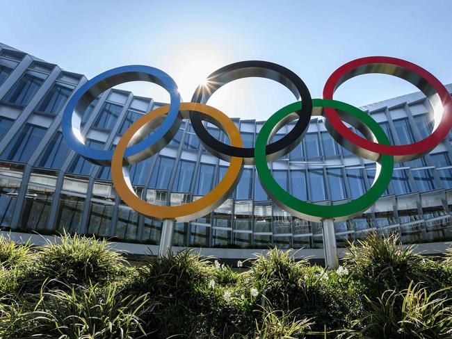 (FILES) In this file photo taken on March 24, 2020, Olympic Rings are seen a the headquarters of the International Olympic Committee (IOC) in Lausanne, amid the spread of the COVID-19. - The International Olympic Committee, thanks to its vast reserves, and international federations, many of which have borrowed money, can cope with the postponement of the Tokyo Games, but a cancellation would have disastrous consequences, experts say. Cushioned by a dozen or so wealthy sponsors, including the French IT group Atos which has just extended its partnership until 2024, and with marketing contracts and television rights still on the rise, the IOC's future looks steady. (Photo by Fabrice COFFRINI / AFP)