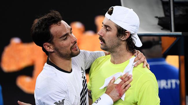 Fabio Fognini of Italy is hugged by Jordan Thompson of Australia after winning match point during his Men's Singles second round match. Picture: Getty