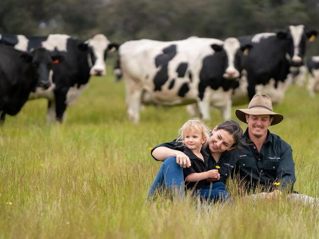 Hayden Russell and partner Beth Gallagher, of The Cheeky Cow Dairy, with daughter Marnie Russell, three and a half, on their dairy farm at Busselton, WA. Pictures: Kira Price