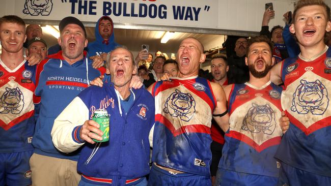 Shane Harvey and father, Neil, sing the song after North Heidelberg’s win. Picture: Hamish Blair