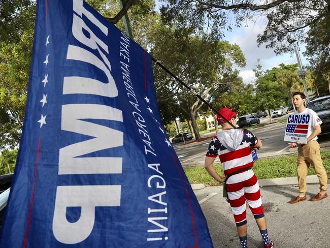 Campaign employees vie for attention in Florida. Picture: AFP