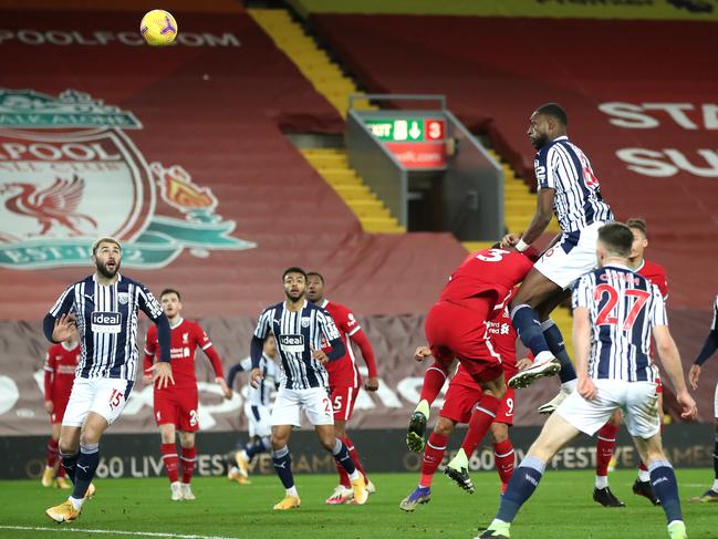 LIVERPOOL, ENGLAND - DECEMBER 27: Semi Ajayi of West Bromwich Albion climbs above Fabinho of Liverpool to score their team's first goal during the Premier League match between Liverpool and West Bromwich Albion at Anfield on December 27, 2020 in Liverpool, England. A limited number of fans (2000) are welcomed back to stadiums to watch elite football across England. This was following easing of restrictions on spectators in tiers one and two areas only. (Photo by Nick Potts - Pool/Getty Images)