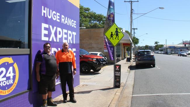 Graham Perandis and owner David 'Crock' Thomas outside Gladstone Battery World on Auckland Street. Picture: Rodney Stevens