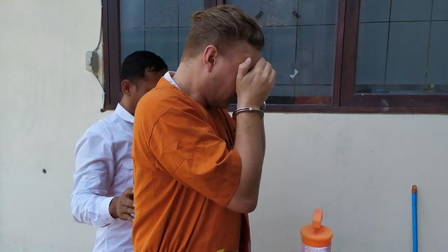 David Van Iersel is led back to his cell after more questioning at Denpasar police station on Monday. Picture: Wayan Nambi Putra