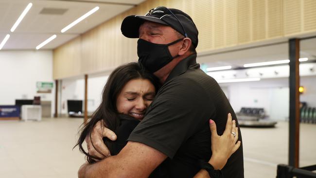 Tara Mrhar is reunited with dad Marly Mrhar after he arrived on the flight from Melbourne at Hobart airport after the borders reopened to Victoria today. Picture: Zak Simmonds