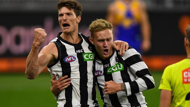 Jaidyn Stephenson enjoys a goal during Collingwood’s elimination final win with Brody Mihocek.