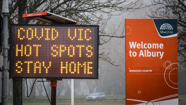 Signs at Albury’s NSW-Victoria border warn of the COVID-19 restrictions