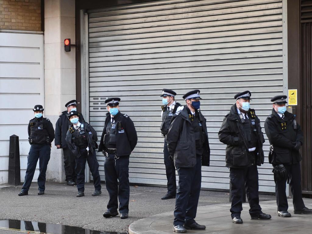 Police stand guard outside the exit to Westminster Magistrates court in London after WikiLeaks founder Julian Assange was denied bail. Picture: AFP