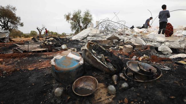 Syrians sift through the rubble at the site of a suspected US-led operation against Islamic State. Picture: AFP