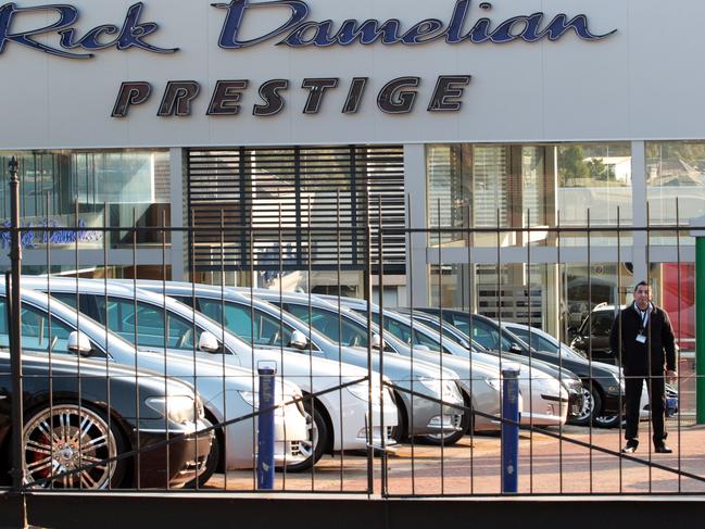 Security guards patrol Rick Damelian Prestige Cars dealership on Parramatta Road, after the business went into receivership.