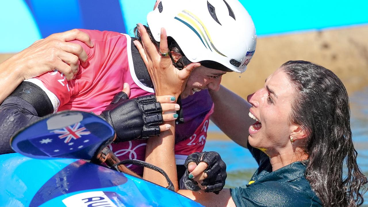 Australia's Noemie Fox (centre) celebrates winning gold with sister Jessica. Picture: John Walton/PA Images via Getty Images