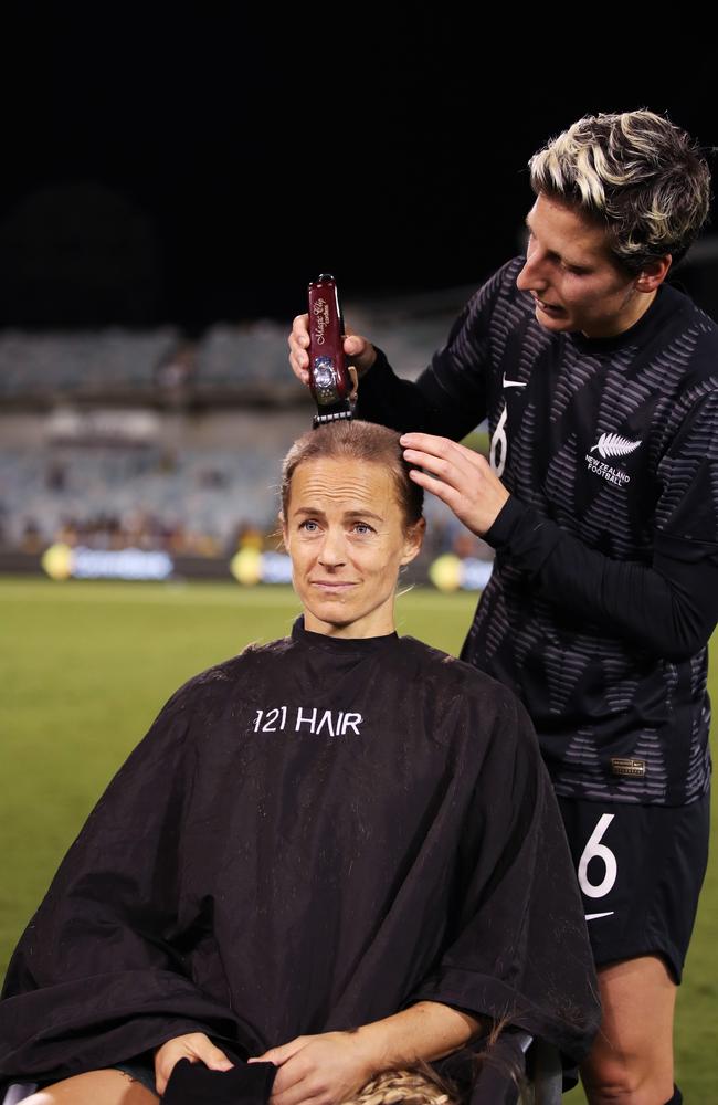 Aivi Luik of the Matildas has her head shaved by Rebekah Stott