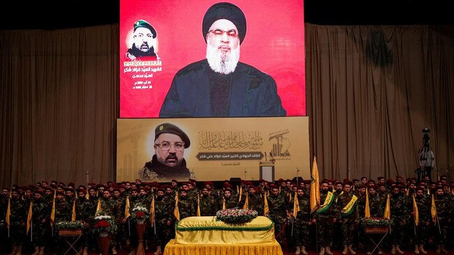 Hezbollah leader Hassan Nasrallah appeared on a screen as he speaks during the funeral of Fuad Shukr, who was killed this week in a strike by Israel. Picture: Alkis Konstantinidis/Reuters/WSJ