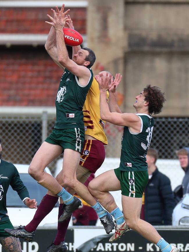 Echuca ruckman Kane Morris flys for a mark in front of opponent Ashley Holland.