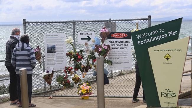 Mourners left flowers at the pier.