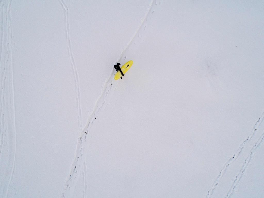 A surfer carries his surfboard as he walks through the snow out of the water on March 11, 2018 in Unstad, northern Norway, Lofoten islands, within the Arctic Circle as air temperature drops minus 13°C and water temperature above 4°C. Picture: AFP