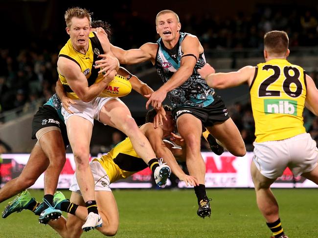 ADELAIDE, AUSTRALIA - JUNE 08: Jack Riewoldt of the Tigers marks in front of Tom Clurey of the Power during the 2018 AFL round 12 match between the Port Adelaide Power and the Richmond Tigers at Adelaide Oval on June 08, 2018 in Adelaide, Australia. (Photo by James Elsby/AFL Media/Getty Images)