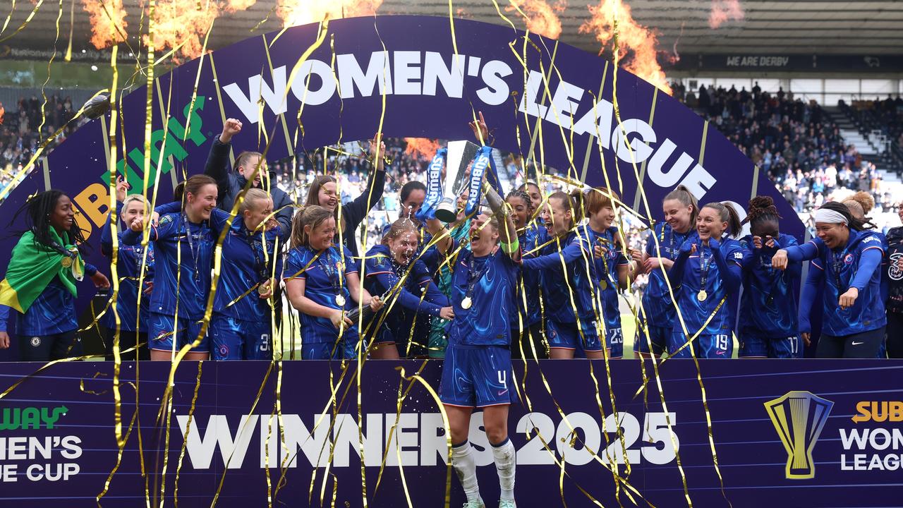 Millie Bright of Chelsea lifts the Women's League Cup. Photo by Nathan Stirk/Getty Images.