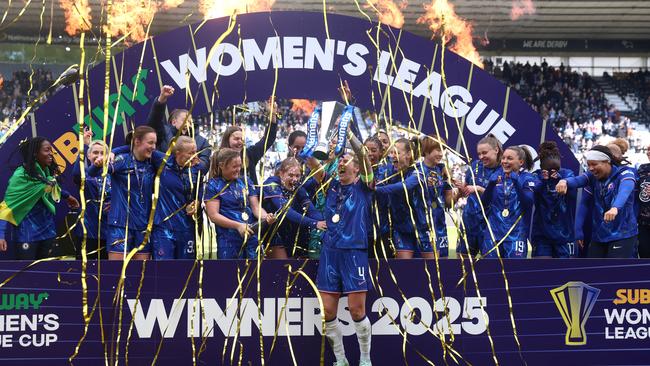 Millie Bright of Chelsea lifts the Women's League Cup. Photo by Nathan Stirk/Getty Images.