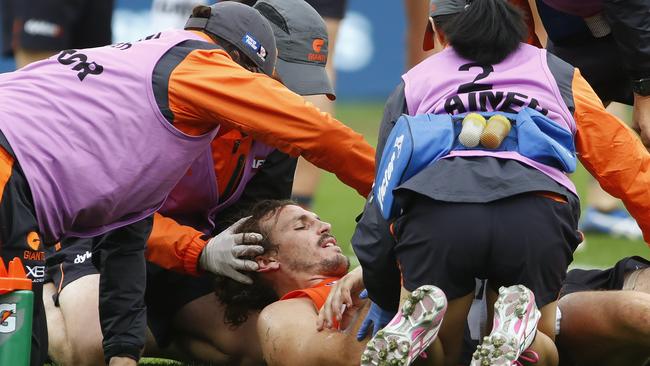 Trainers attend to Phil Davis after he copped a stray elbow to the head from Eagle Jack Darling.