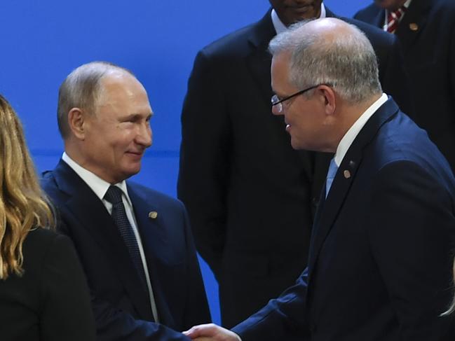 Australian Prime Minister Scott Morrison (right) shakes hands with President of Russia Vladimir Putin ahead of the family picture at the G20 summit in Buenos Aires, Argentina, Friday, November 30, 2018. The leaders of the world's largest economies arrived in Buenos Aires on Thursday for the first G20 summit to be held in South America. (AAP Image/Lukas Coch) NO ARCHIVING