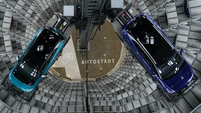 Volkswagen ID.4, right, and ID.3 electric cars stand on elevator platforms inside one of the twin towers used as storage at the Autostadt promotional facility next to the Volkswagen in Wolfsburg, Germany. Volkswagen posted a profit in the third quarter. Picture: Getty Images