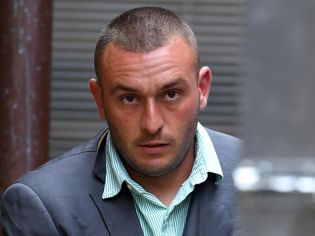 Diego Carbone is led to a prison transfer van at the NSW Supreme Court in Sydney, Thursday, March 22, 2018. Carbone has been sentenced to at least 21 years in prison for murdering father of two Bradley Dillon who was shot and stabbed after being lured to a Leichhardt car park in August 2014. (AAP Image/Dan Himbrechts) NO ARCHIVING