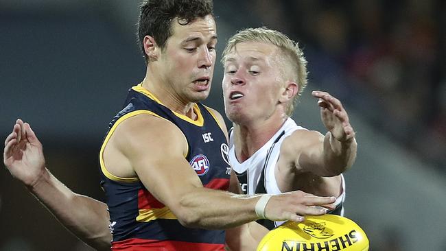 Luke Brown gets his kick away from Jaidyn Stephenson. Picture: Sarah Reed