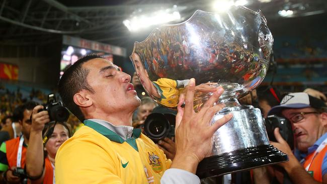 Tim Cahill of Australia kisses the Asian Cup Trophy.