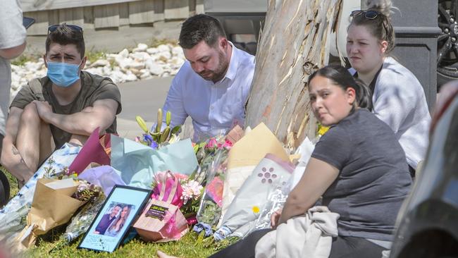 Celeste’s boyfriend Chris is surrounded by mourners at the scene outside the house. Picture: Jay Town