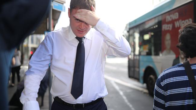 A camera-shy Justin Murray leaves court earlier this month. Picture: Christian Gilles