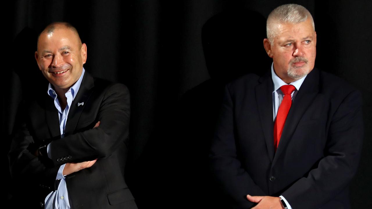 Eddie Jones laughs as Warren Gatland looks unimpressed.