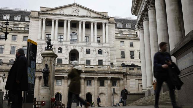 Pedestrians walk by the Royal Exchange and the Bank of England in the City of London. Picture: AFP