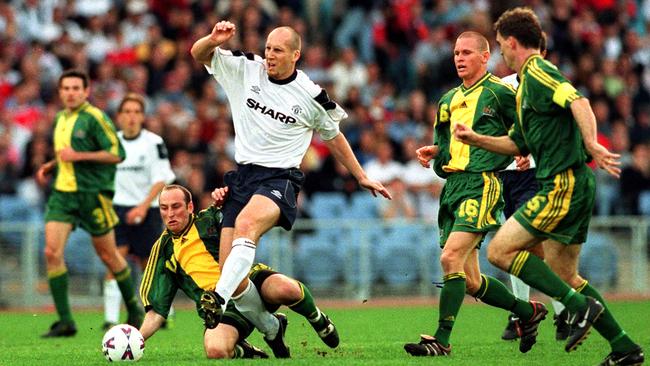 Manchester United’s Jaap Stam takes on the Socceroos in 1999