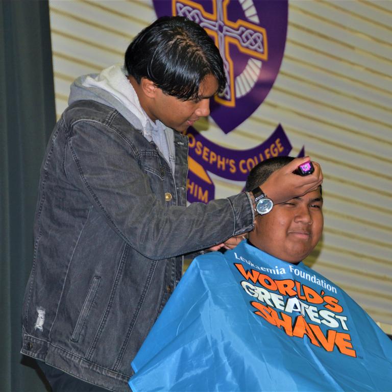 At the St Joseph's College 2023 World's Greatest Shave event is student Johann Ferrer getting his hair cut by his older brother Jeffrey Ferrer. Picture: Rhylea Millar