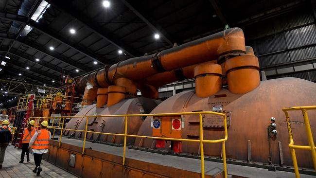 Workers walk past decommissioned machinery as Liddell Power Station closes. Picture: NCA NewsWire / Bianca De Marchi