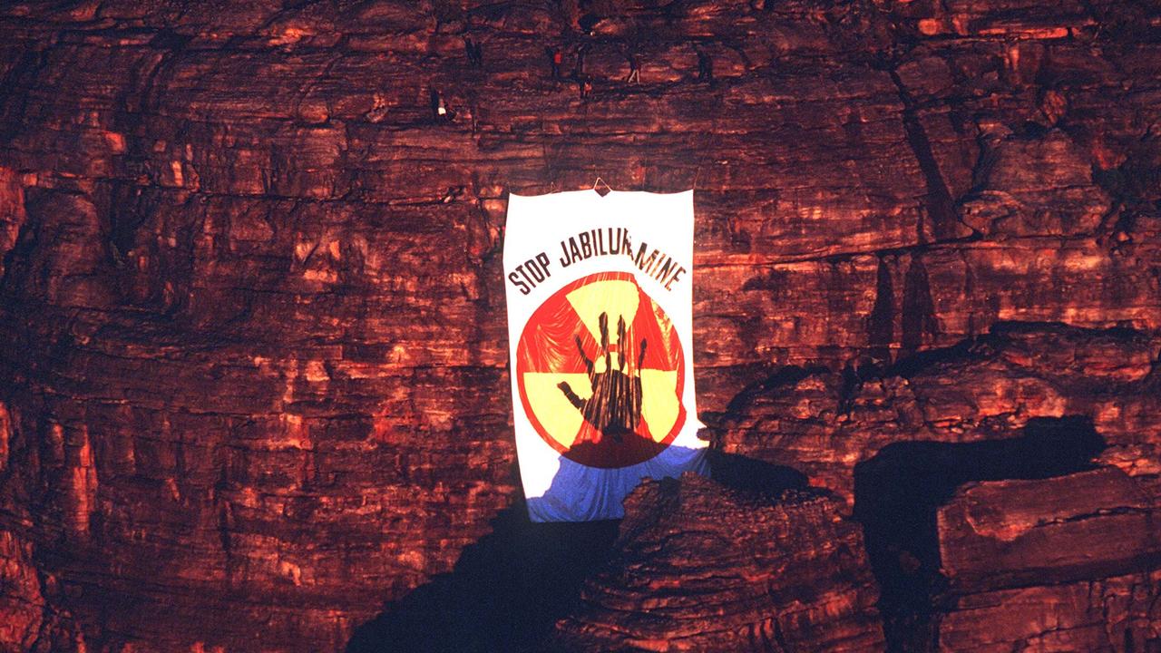 Ten Mirarr Traditional Owners dropped a giant 'Stop Jabiluka Mine' banner from a cliff face overlooking Oenpelli Rd in June 1997. Picture: Supplied