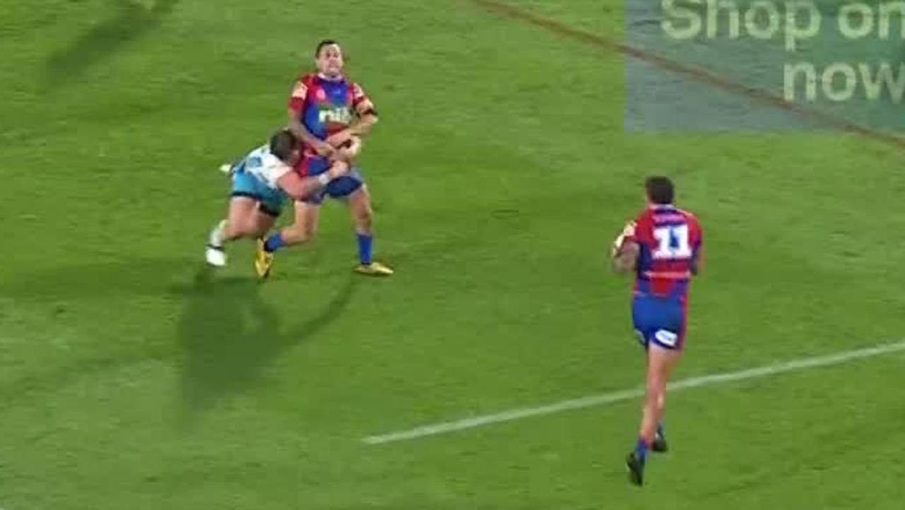 Mitchell Pearce is tackled by Jarrod Wallace.
