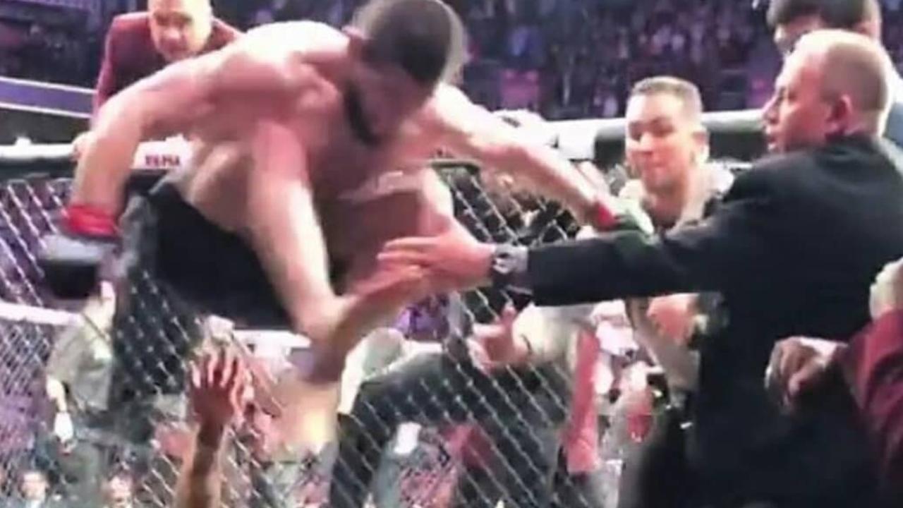 Khabib Nurmagomedov leaps into the crowd at the end of the bout.