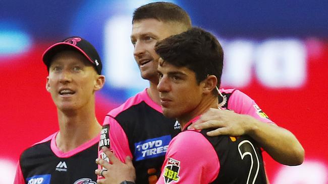 The Sixers’ Jackson Bird (centre) and Moises Henriques celebrate after combining to dismiss Renegades batsman Shaun Marsh on Thursday night. Picture: Getty Images