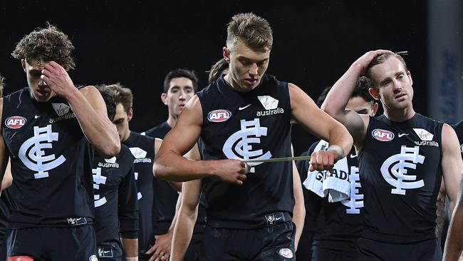 Carlton players trudge off the field after copping a thumping from North Melbourne. Picture: AAP