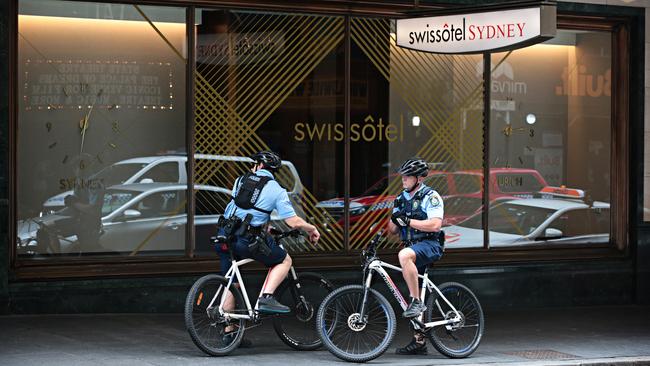 Police patrol outside Sydney’s Swissotel, which has taken in cruise passengers in quarantine.