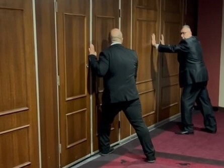 Security guards hold the doors to the conference room as protesters try to enter. Picture: Supplied