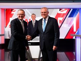 Australian Prime Minister Scott Morrison (right) and Australian Opposition Leader Anthony Albanese shake hands during the third leaders' debate at Seven Network Studios on Day 31 of the 2022 federal election campaign, in Sydney, Wednesday, May 11, 2022. (AAP Image/Lukas Coch) 