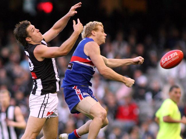 Dane Swan and Adam Cooney face off on the footy field.