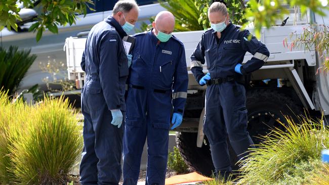 Forensic specialists at the scene. Picture: Andrew Henshaw