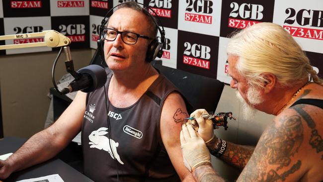 Afternoons host Chris Smith receives a Rabbitohs tattoo on-air. Picture: Craig Greenhill