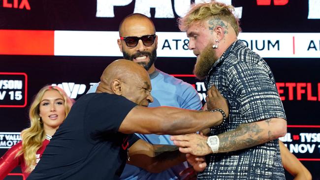 (L-R) Former US heavyweight boxing champion Mike Tyson and US YouTuber and boxer Jake Paul face off during a press conference at Fanatics Fest NYC on August 18, 2024, in New York City. The heavyweight match has been rescheduled for November 15, 2024, and will take place in Arlington, Texas. (Photo by TIMOTHY A. CLARY / AFP)